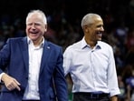Former US President Barack Obama (R) smiles next to Minnesota Governor and Democratic vice presidential candidate Tim Walz after speaking during a campaign rally in support of Vice President and Democratic presidential candidate Kamala Harris, at Alliant Center in Madison, Wisconsin, on October 22, 2024. 