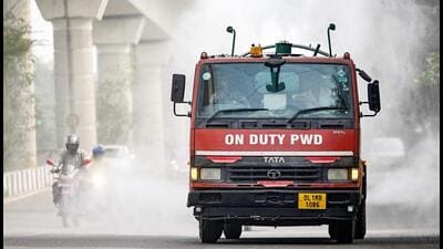 A vehicle of the Public Works Department (PWD) sprays water using an anti-smog gun to curb air pollution amid smoggy conditions in New Delhi on October 23, 2024. Acrid clouds engulfed India's capital on October 23, as air pollution fuelled by fireworks and farm stubble burning was ranked "hazardous" by monitors for the first time this winter. (AFP)