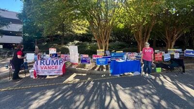 Both Rpublicans and Democrats put out their final messages to persuade voters at the Herbert Young polling centre in Wake County, North Carolina on Tuesday.