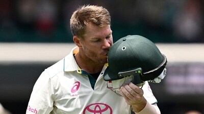 Australia's David Warner kisses the coat of arms on his helmet as he leaves the field in his last test match. (REUTERS)