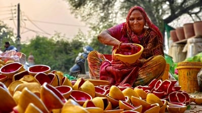 A woman colours earthen lamps for the upcoming Diwali festival, in Amritsar, Tuesday. (PTI) A woman colours earthen lamps for the upcoming Diwali festival, in Amritsar, Tuesday. (PTI)