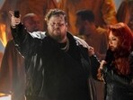 Jelly Roll, left, and Wynonna Judd perform "Need a Favor" at the 57th Annual CMA Awards on Wednesday, Nov. 8, 2023, at the Bridgestone Arena in Nashville, Tenn. (AP Photo/George Walker IV)
