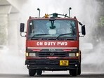 A vehicle of the Public Works Department (PWD) sprays water using an anti-smog gun to curb air pollution amid smoggy conditions in New Delhi. (AFP)