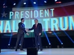 FILE - Former President Donald Trump, right, shakes hands with Turning Point CEO Charlie Kirk before speaking during the Turning Point USA Student Action Summit, Saturday, July 23, 2022, in Tampa, Fla. (AP Photo/Phelan M. Ebenhack, File)