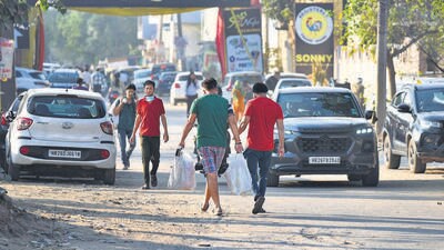 A man carries bags of fireworks outside a wholesale market in Gurugram on Thursday. (Parveen Kumar/HT Photo) A man carries bags of fireworks outside a wholesale market in Gurugram on Thursday. (Parveen Kumar/HT Photo)