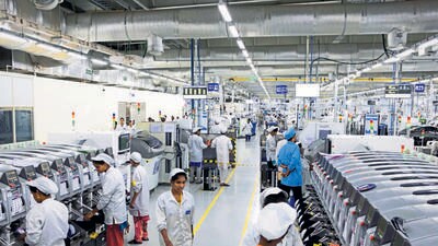 Employees work on an assembly line. (Bloomberg)
