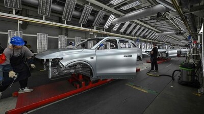Employees work on an electric vehicle at a factory in Jinhua, China. (AFP) Employees work on an electric vehicle at a factory in Jinhua, China. (AFP)