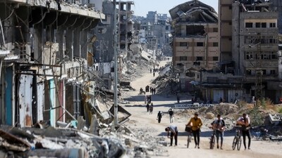 Palestinians make their way in a devasted neighbourhood amid the ongoing Israel-Hamas conflict, in Gaza City, October 24, 2024. (Reuters)