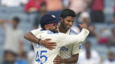 India's Washington Sundar and captain Rohit Sharma celebrates the dismissal of New Zealand's Tim Southee on day one of the second Test in Pune on Thursday. (AP) India's Washington Sundar and captain Rohit Sharma celebrates the dismissal of New Zealand's Tim Southee on day one of the second Test in Pune on Thursday. (AP)
