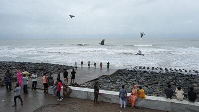 Visitors at the beach in Digha, West Bengal ahead of the landfall of Cyclone 'Dana'. (PTI Photo) Visitors at the beach in Digha, West Bengal ahead of the landfall of Cyclone 'Dana'. (PTI Photo)