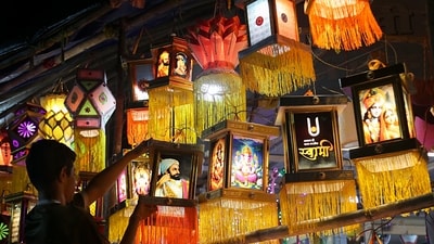 A shop assistant arranges decorative lanterns at a store in Nagpur on Wednesday, preparing for the upcoming Diwali festival. (ANI Photos) A shop assistant arranges decorative lanterns at a store in Nagpur on Wednesday, preparing for the upcoming Diwali festival. (ANI Photos)
