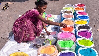 A woman vendor arranges colourful 'Rangoli' powders in preparation for the Diwali festival in Surat. (ANI Photos) A woman vendor arranges colourful 'Rangoli' powders in preparation for the Diwali festival in Surat. (ANI Photos)
