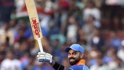 Virat Kohli raises his bat after reaching the landmark of 10,000 runs in one-day internationals during the second ODI match against West Indies in Visakhapatnam. (AP Photo) Virat Kohli raises his bat after reaching the landmark of 10,000 runs in one-day internationals during the second ODI match against West Indies in Visakhapatnam. (AP Photo)