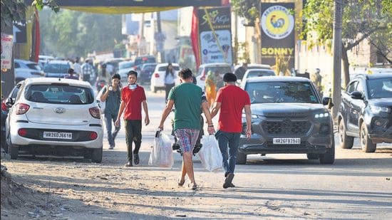 A man carries bags of fireworks outside a wholesale market in Gurugram on Thursday. (Parveen Kumar/HT Photo)