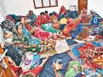 Evacuated villagers rest at a cyclone shelter ahead of the cyclone 'Dana' landfall in Bhadrak district on Thursday. 