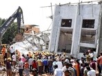 National Disaster Response Force (NDRF) and Fire personnel conduct a search and rescue operation for the workers trapped under the collapsed six-story under-construction building, at Babusapalya in Bengaluru on Wednesday. (ANI)