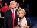 FILE PHOTO: FILE PHOTO: Republican U.S. presidential nominee Donald Trump listens as Democratic nominee Hillary Clinton answers a question from the audience during their presidential town hall debate at Washington University in St. Louis, Missouri, U.S., October 9, 2016. REUTERS/Rick Wilking/File Photo/File Photo