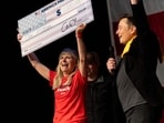 SpaceX and Tesla founder Elon Musk awarded Kristine Fishell with a $1 million check during the town hall at the Roxain Theater on October 20, 2024 in Pittsburgh, Pennsylvania. 