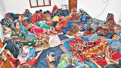 Evacuated villagers rest at a cyclone shelter ahead of the cyclone 'Dana' landfall in Bhadrak district on Thursday. (PTI) Evacuated villagers rest at a cyclone shelter ahead of the cyclone 'Dana' landfall in Bhadrak district on Thursday. (PTI)