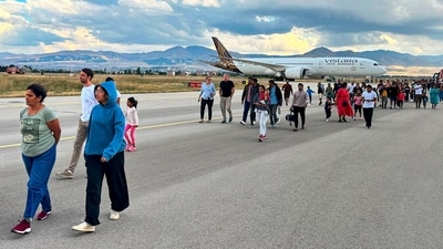 Passengers of the Vistara flight VTI027 from Mumbai to Frankfurt walk along the tarmac as they leave the plane at the Erzurum airport in eastern Turkey, Friday,. The Vistara airline flight made a forced landing in Turkey on Friday following a bomb threat, Turkish officials said. (AP) Passengers of the Vistara flight VTI027 from Mumbai to Frankfurt walk along the tarmac as they leave the plane at the Erzurum airport in eastern Turkey, Friday,. The Vistara airline flight made a forced landing in Turkey on Friday following a bomb threat, Turkish officials said. (AP)