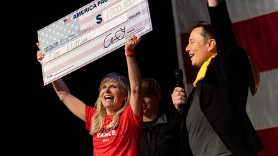 SpaceX and Tesla founder Elon Musk awarded Kristine Fishell with a $1 million check during the town hall at the Roxain Theater on October 20, 2024 in Pittsburgh, Pennsylvania. (Getty Images via AFP) SpaceX and Tesla founder Elon Musk awarded Kristine Fishell with a $1 million check during the town hall at the Roxain Theater on October 20, 2024 in Pittsburgh, Pennsylvania. (Getty Images via AFP)