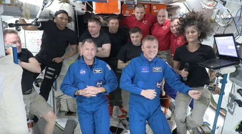 In this image made from a NASA livestream, the two astronauts stuck at the International Space Station since June 2024, Butch Wilmore, far left, and Suni Williams, far right, welcome two new residents who flew up on SpaceX, NASA's Nick Hague, front left in blue, and the Russian Space Agency's Alexander Gorbunov, front right in blue, Sunday, Sept. 29, 2024. Behind them, from left in black, are NASA's Jeanette Epps, Russia's Alexander Grebenkin, NASA's Mike Barratt and NASA's Matthew Dominick. From left, wearing red, are Russia's Ivan Vagner, NASA's Don Pettit and Russia's Alexei Ovchinin. (AP) In this image made from a NASA livestream, the two astronauts stuck at the International Space Station since June 2024, Butch Wilmore, far left, and Suni Williams, far right, welcome two new residents who flew up on SpaceX, NASA's Nick Hague, front left in blue, and the Russian Space Agency's Alexander Gorbunov, front right in blue, Sunday, Sept. 29, 2024. Behind them, from left in black, are NASA's Jeanette Epps, Russia's Alexander Grebenkin, NASA's Mike Barratt and NASA's Matthew Dominick. From left, wearing red, are Russia's Ivan Vagner, NASA's Don Pettit and Russia's Alexei Ovchinin. (AP)