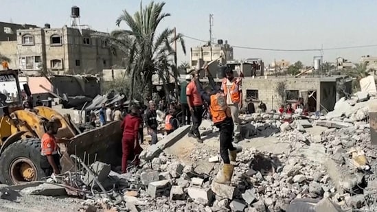 Palestinians check a building destroyed by Israeli airstrikes in the city of Khan Younis, southern Gaza Strip, Friday, Oct. 25, 2024. (AP)