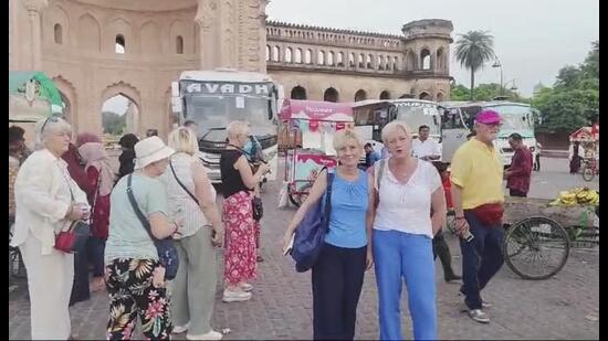 Tourists taking photographs in front of Rumi Gate on Thursday with buses in the background. (Sourced)