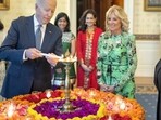 US President Joe Biden lights a lamp as First lady Jill Biden and Vice-President Kamala Harris look on during an event to celebrate Diwali, at the White House in Washington. (PTI)