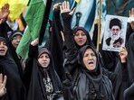 Women raise their hands and chant slogans while one holds a picture of Iran's Supreme Leader Ayatollah Ali Khamenei during an anti-Israel rally in Tehran Women raise their hands and chant slogans while one holds a picture of Iran's Supreme Leader Ayatollah Ali Khamenei during an anti-Israel rally in Tehran