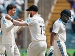 Mitchell Santner celebrates with Daryl Mitchell after taking the wicket of India's captain Rohit Sharma. Mitchell Santner celebrates with Daryl Mitchell after taking the wicket of India's captain Rohit Sharma.