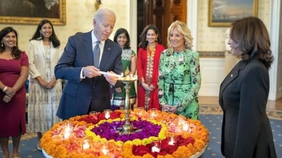 US President Joe Biden lights a lamp as First lady Jill Biden and Vice-President Kamala Harris look on during an event to celebrate Diwali, at the White House in Washington. (PTI) US President Joe Biden lights a lamp as First lady Jill Biden and Vice-President Kamala Harris look on during an event to celebrate Diwali, at the White House in Washington. (PTI)