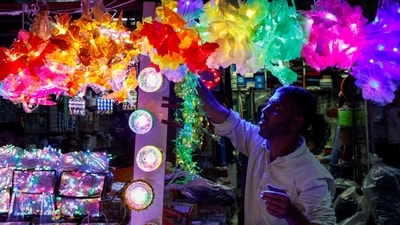 A shopkeeper arranges decorative lights for sale ahead of Diwali celebrations, the Hindu festival of lights, in Kolkata on October 25. (REUTERS) 