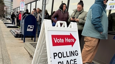 People stand in line waiting to cast ballots during early voting in the general election on a cool and windy day, Friday, Oct. 25, 2024, in Anchorage, Alaska. (AP) People stand in line waiting to cast ballots during early voting in the general election on a cool and windy day, Friday, Oct. 25, 2024, in Anchorage, Alaska. (AP)