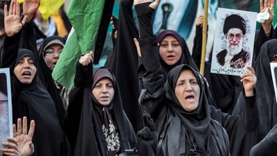 Women raise their hands and chant slogans while one holds a picture of Iran's Supreme Leader Ayatollah Ali Khamenei during an anti-Israel rally in Tehran (AFP) Women raise their hands and chant slogans while one holds a picture of Iran's Supreme Leader Ayatollah Ali Khamenei during an anti-Israel rally in Tehran (AFP)