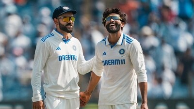 India's Ravindra Jadeja celebrates with Virat Kohli after taking the wicket of New Zealand's Ajaz Patel on the third day of the second test cricket match between India and New Zealand, at the Maharashtra Cricket Association Stadium (PTI)