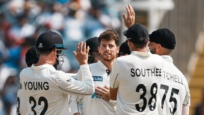New Zealand's Mitchell Santner celebrates with teammates after taking the wicket of India's captain Rohit Sharma on the third day of the second test cricket match between India and New Zealand, at the Maharashtra Cricket Association Stadium, in Pune, Saturday, Oct. 26, 2024 (PTI) New Zealand's Mitchell Santner celebrates with teammates after taking the wicket of India's captain Rohit Sharma on the third day of the second test cricket match between India and New Zealand, at the Maharashtra Cricket Association Stadium, in Pune, Saturday, Oct. 26, 2024 (PTI)