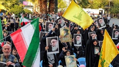 Demonstrators wave flags of Iran, Lebanese Hezbollah, and pictures of Iran's Supreme Leader Ayatollah Ali Khamenei during an anti-Israel rally in Tehran on October 24, 2024. (AFP) Demonstrators wave flags of Iran, Lebanese Hezbollah, and pictures of Iran's Supreme Leader Ayatollah Ali Khamenei during an anti-Israel rally in Tehran on October 24, 2024. (AFP)