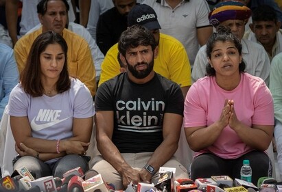 Indian wrestlers Vinesh Phogat, Bajrang Punia, and Sakshi Malik address a news conference. (HT)
