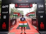 Bharatiya Janata Party (BJP) MP Tejasvi Surya holding the national flag poses for a picture after becoming the first public representative to complete the gruelling 'Ironman 70.3 endurance Goa', on Sunday.