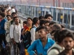 People gather in the evening to catch Gorakhpur train at Bandra terminus in Mumbai, on Sunday.