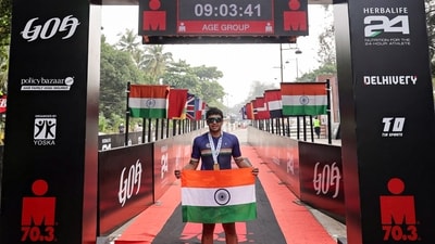 Bharatiya Janata Party (BJP) MP Tejasvi Surya holding the national flag poses for a picture after becoming the first public representative to complete the gruelling 'Ironman 70.3 endurance Goa', on Sunday. ( Tejasvi Surya-X) Bharatiya Janata Party (BJP) MP Tejasvi Surya holding the national flag poses for a picture after becoming the first public representative to complete the gruelling 'Ironman 70.3 endurance Goa', on Sunday. ( Tejasvi Surya-X)