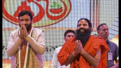 Haryana chief minister Nayab Singh Saini with Yog guru Baba Ramdev and others during the annual celebrations of Acharyakulam in Haridwar on Sunday. (PTI)