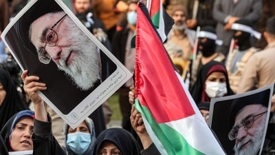 A woman holds a Palestinian flag and a picture of Iran's Supreme Leader Ayatollah Ali Khamenei during an anti-Israel rally in Tehran. (Photo by AFP) A woman holds a Palestinian flag and a picture of Iran's Supreme Leader Ayatollah Ali Khamenei during an anti-Israel rally in Tehran. (Photo by AFP)