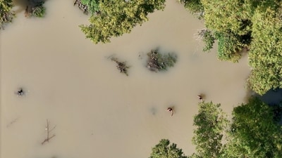 An aerial view of people wading through a flooded area in Philippines (AFP)