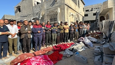 Palestinians pray over bodies of relatives, killed in an overnight Israeli airstrike, in Beit Lahia the northern Gaza Strip on October 27, 2024 amid the ongoing war in the Palestinian territory between Israel and Hamas. (Photo by AFP) (AFP) Palestinians pray over bodies of relatives, killed in an overnight Israeli airstrike, in Beit Lahia the northern Gaza Strip on October 27, 2024 amid the ongoing war in the Palestinian territory between Israel and Hamas. (Photo by AFP) (AFP)