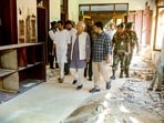 Nobel laureate and chief adviser of Bangladesh's interim government Muhammad Yunus (4L) as he tours the battered Gonobhaban palace, the former official residence of the ousted prime minister Sheikh Hasina in Dhaka. 