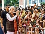 Prime Minister Narendra Modi being greeted by women BJP MPs and party workers during the 'Nari Shakti Vandan-Abhinandan Karyakram, a day after Parliament passed the women's reservation bill. (Hindustan Times)
