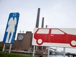 File photo: A woman walks past a factory at Volkswagen AG headquarters, in Wolfsburg, Germany.
