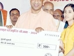 UP CM Yogi Adityanath handed over cheques worth  <span class='webrupee'>₹</span>300 to Sanskrit students. (X)